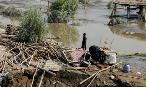 A man stands in his ruined house after the Pakistan floods.