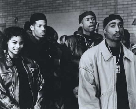 A black-and-white film still from Above the Rim, with (left to right) Denise Warner, Marlon Wayans, Sherwin David Harris, and Tupac Shakur.