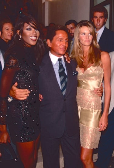 Valentino with his arms around the waists of supermodels Naomi Campbell and Elle MacPherson