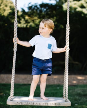 Prince George playing on a swing.