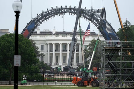 Large metal arches being installed on a lawn