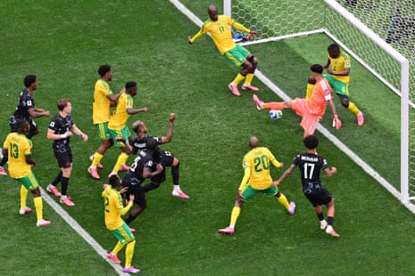 Canada’s Moise Bombito heads the ball but is denied by South Africa's Aubrey Modiba.