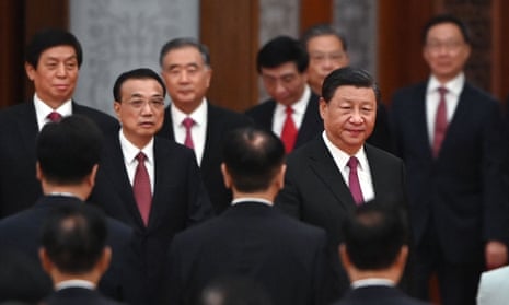 Xi surrounded by senior Communist party officials in dark suits and red ties