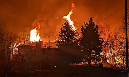 A house is engulfed in flames in Boulder county, Colorado, last month as the wildfire season grows longer and blazes affected more suburban areas.