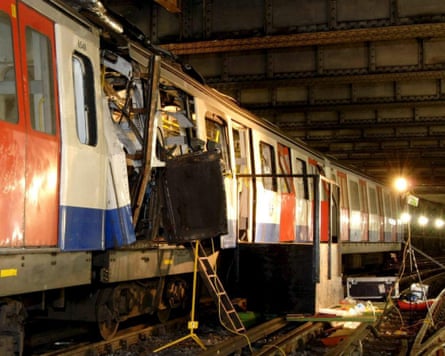 Badly damaged side of a London Underground carriage.