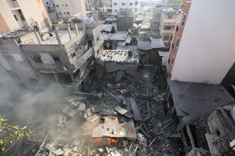 Palestinians inspect a house destroyed in an Israeli strike in Khan Younis.