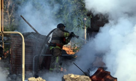 A rescue worker attends a fire caused by a Russian missile attack, in Kharkiv, northeastern Ukraine.