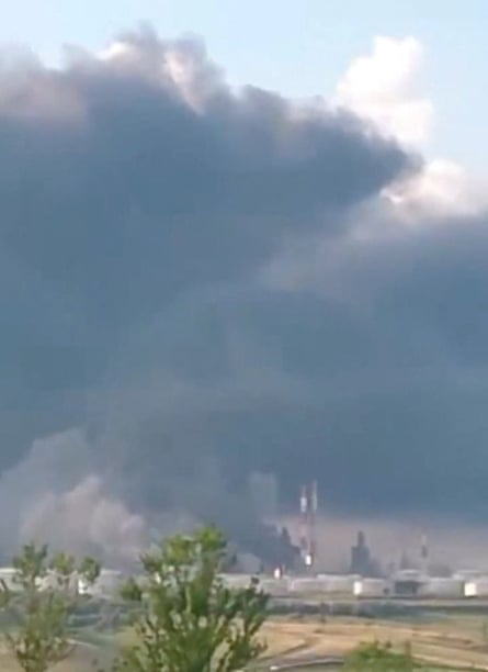 A huge cloud of smoke rises from a refinery