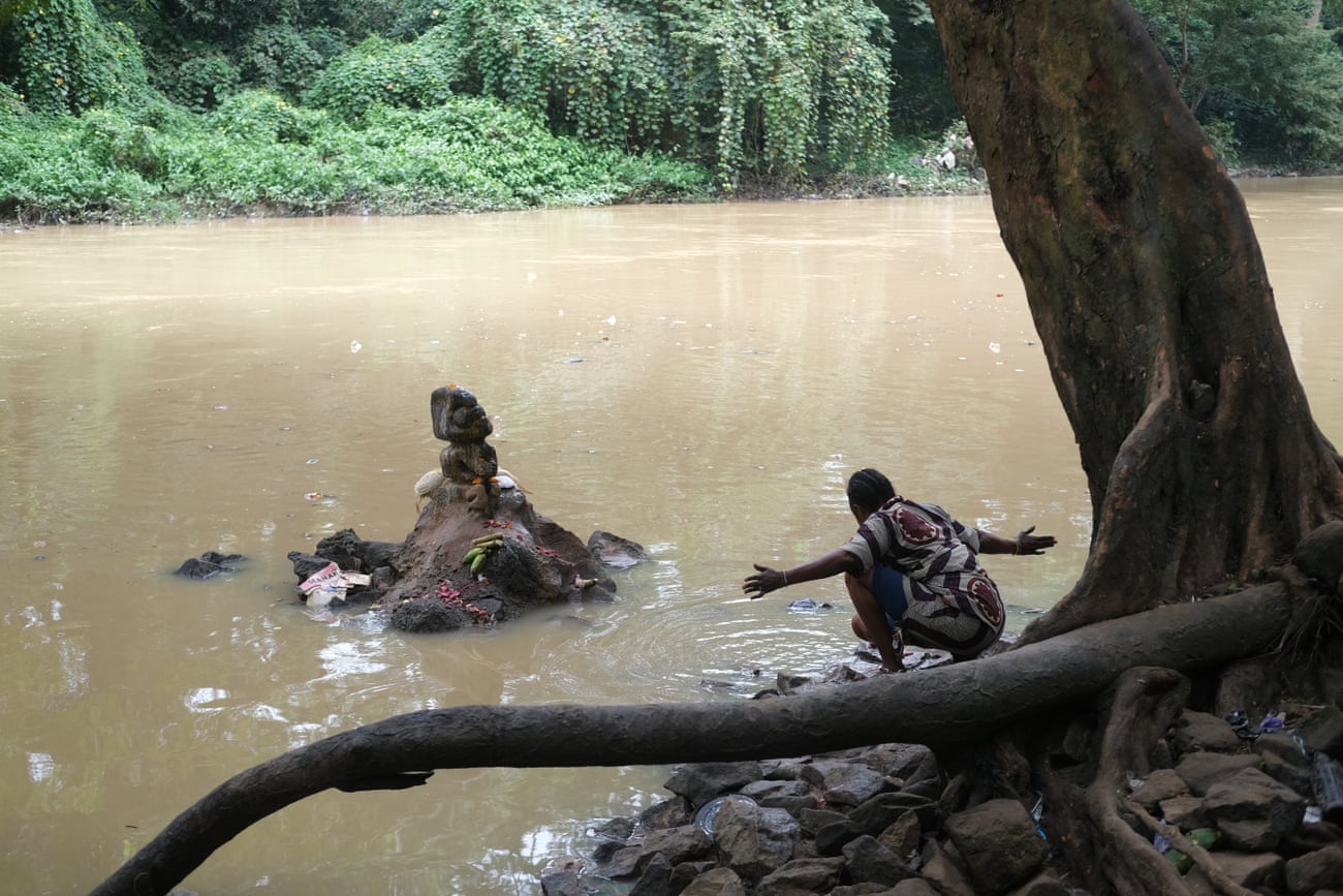 Prayers at the edge of the river.