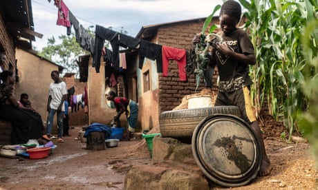 Fetching water from a well to wash clothes in Mtandile in Lilongwe, Malawi.