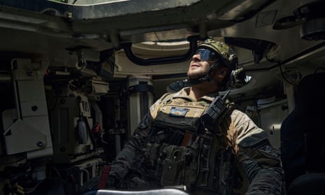 A Ukrainian soldier inside an armoured recovery vehicle on the frontline in the Zaporizhzhia region.