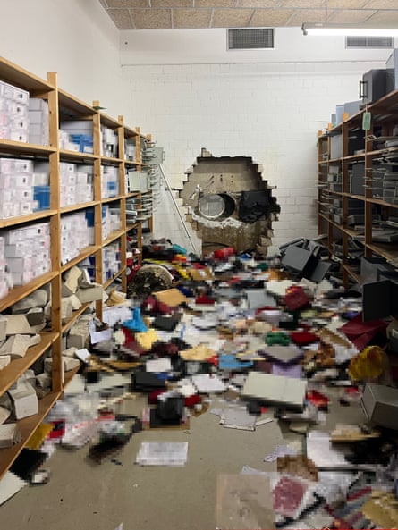 The vault which has a large hole cut into it and boxes and documents strewn over the floor