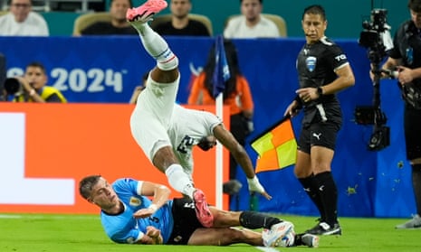 Michael Murillo tumbles over Uruguay's Manuel Ugarte in their game Sunday.
