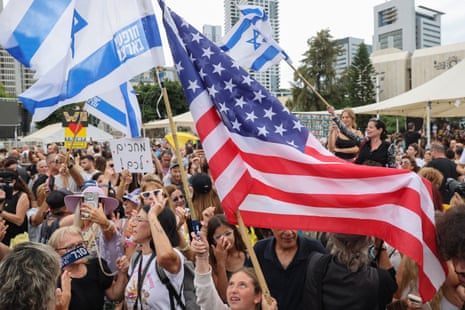 People wave US and Israeli flags at Hostage Square in Tel Aviv on Thursday to celebrate the Gaza ceasefire deal.