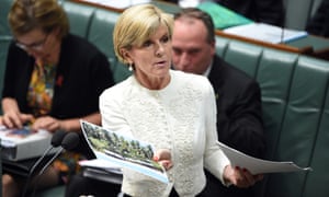 Minister for Foreign Affairs Julie Bishop holds up a photo of the island of Eneko in the Marshall Islands to mock Tanya Plibersek on Tuesday.