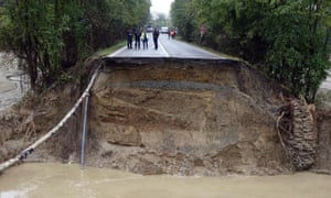 A collapsed road in Piedmont, Italy. Two people are dead and two others are missing after a wave of storms in northern Italy. 