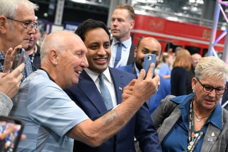 Zia Yusuf taking a selfie with supporters.