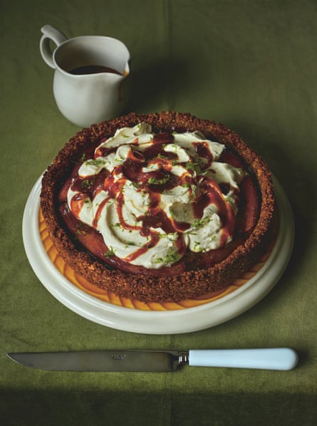 pie on a plate with knife and jug of sauce