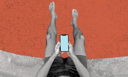 anonymous man in bathing shorts using a smartphone viewed from above