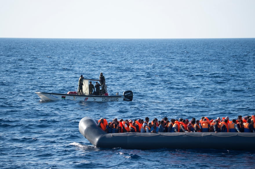 A Libyan coastguard vessel intercepts a rubber boat with around 150 people onboard off the Libyan coast