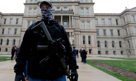 An armed protester stands outside the Michigan state capitol on 15 April.
