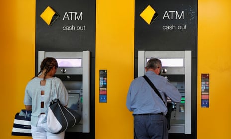 People withdraw cash from ATMs
