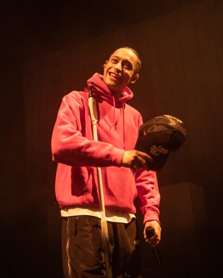 Loyle Carner, smiling, with his baseball cap in his hand, at the Hammersmith Apollo