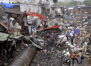 Illegal homes near the water pipeline are demolished in Dharavi.