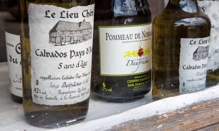 Bottles of calvados in a shop window in the Pays d’Auge region of Normandy