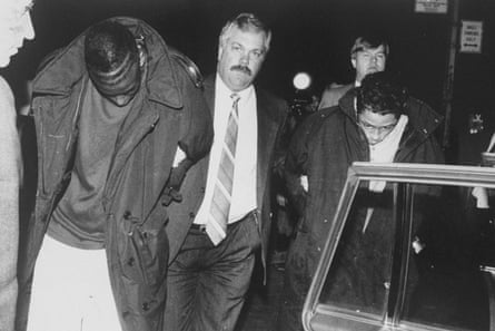 Yusef Salaam, left, is led away by a detective after being arrested in April 1989 for allegedly attacking a jogger in New York.