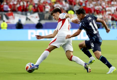 Arda Guler (L) of Turkey in action against Andres Cubas of Paraguay.