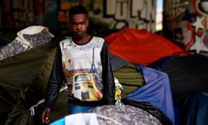 A migrant leaving a camp in Paris