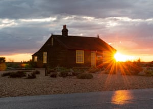 The sun sets behind Prospect Cottage, towards Lydd