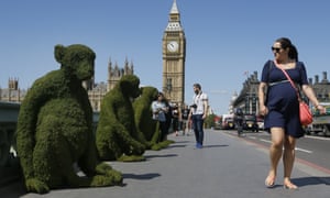 Monkey models placed on Westminster bridge in London to mark the launch of ‘bio-birdges’ make passersby curious.
