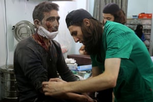 Medics at a makeshift hospital in the Tariq al-Bab district treat a man wounded in an air raid