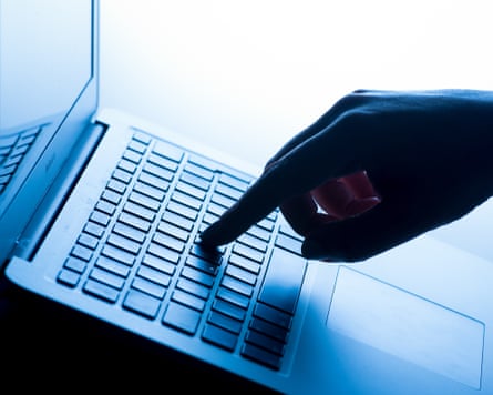 a hand taps a message on a laptop