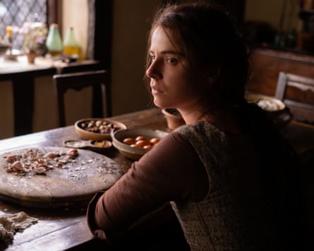A woman sitting at a table with bowls and food in front of her