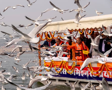 Chief minister of Uttar Pradesh state Yogi Adityanath feeding seagulls off a boat