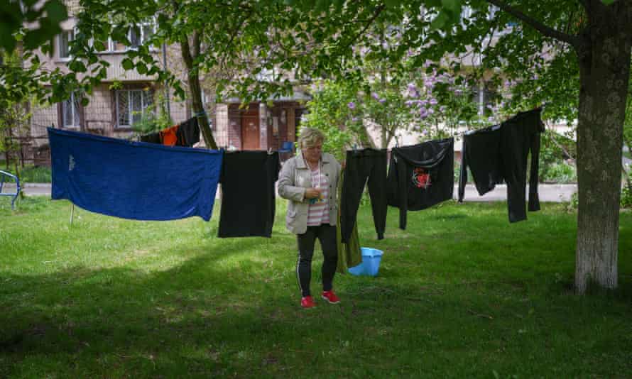 A resident of Bucha puts out her washing to dry.