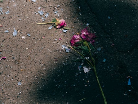 Flowers and glass shards on the ground