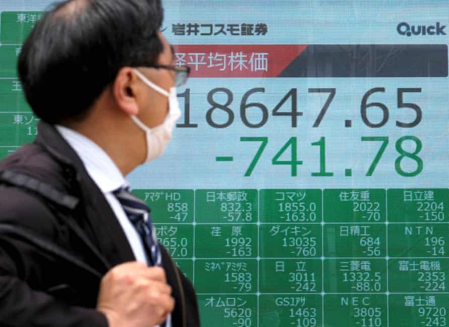 A quotation board shows falling share prices on the Tokyo Stock Exchange.