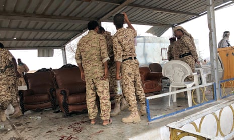 Soldiers inspect  scene after drone attack at al-Anad airbase