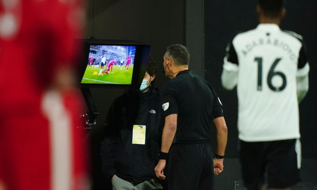 The referee Andre Marriner refers to the VAR monitor before overruling his decision to award Fulham a penalty against Liverpool last Sunday.