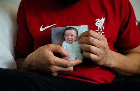 Aaron Willis holds a picture of his son