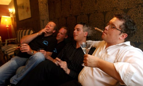 a group of men smoking and drinking inside
