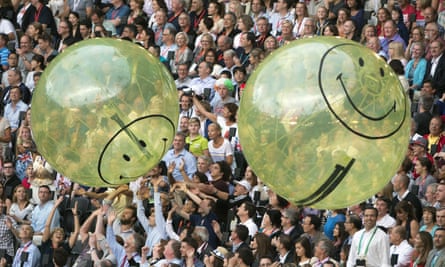 Spectator crowds play with Smiley beach balls at the 2012 Olympics.