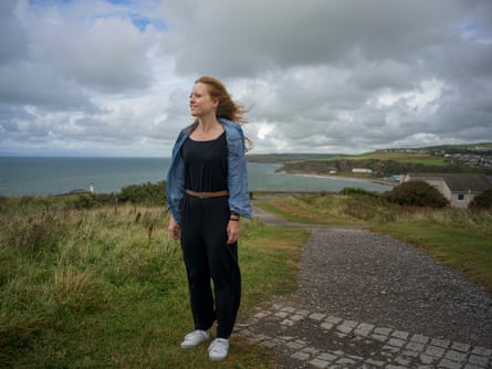 A woman standing on a headland path