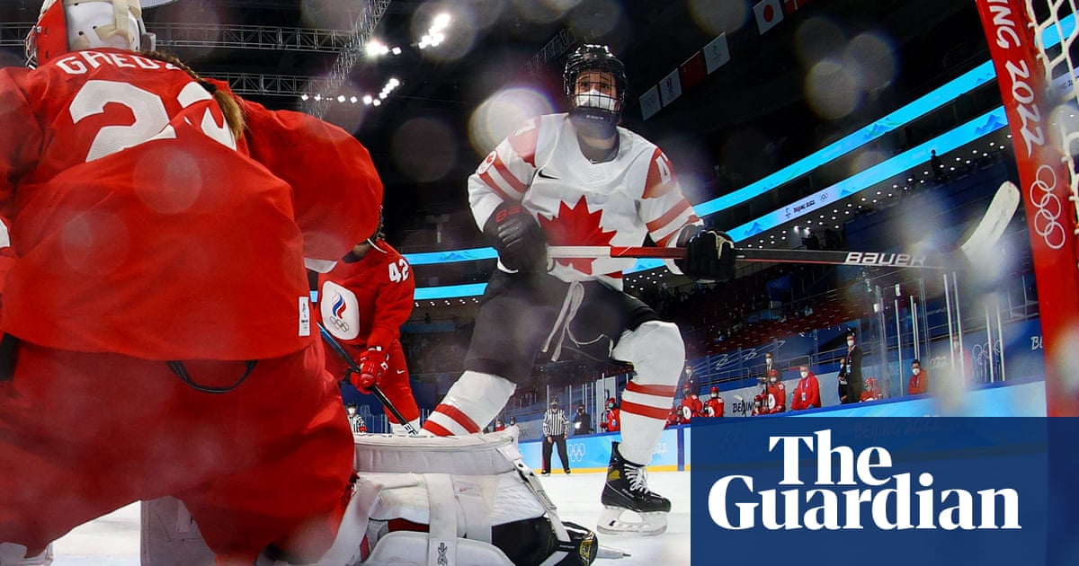 Olympic hockey match delayed before players return to ice in masks under helmets