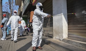 Workers disinfect closed shop lots in the Jiang’an District of Wuhan.