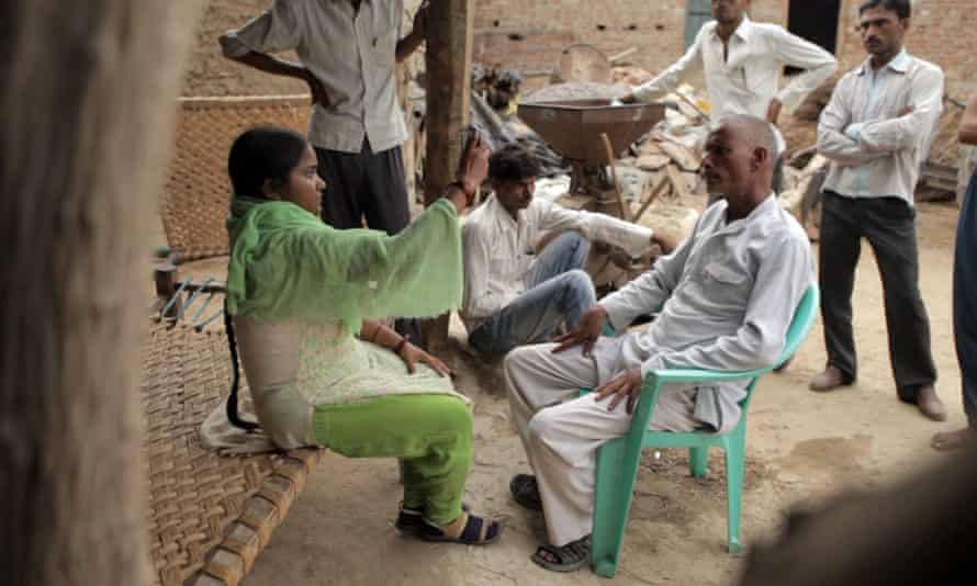 Meera Devi, a Khabar Lahariya journalist, interviews a man in Storyville's 'stunning' Writing With Fire